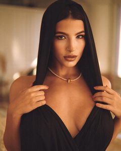 LaSirena69 en vestido negro elegante.